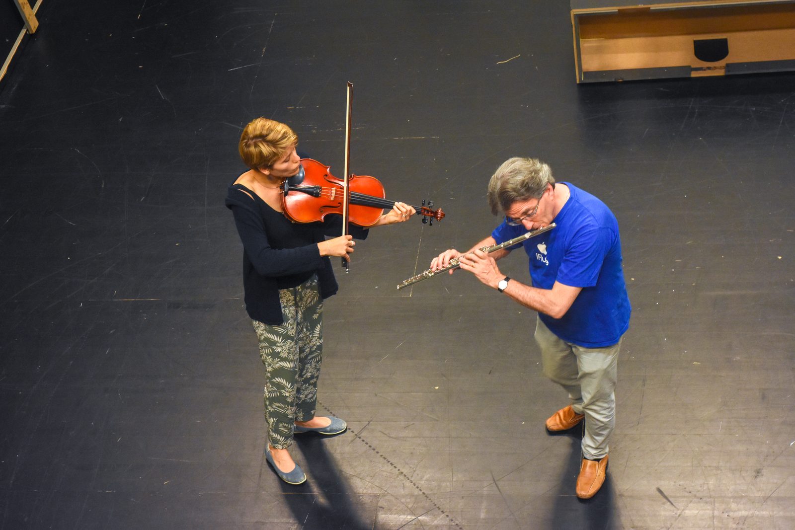 Overhead view of the flute and viola performers in the rehearsal space.